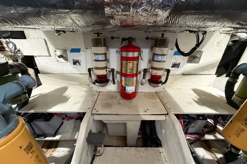 Slide: The Image of Engine room of 1998 Tiara Yachts 4000 Express with fire extinguisher and equipment. - 24