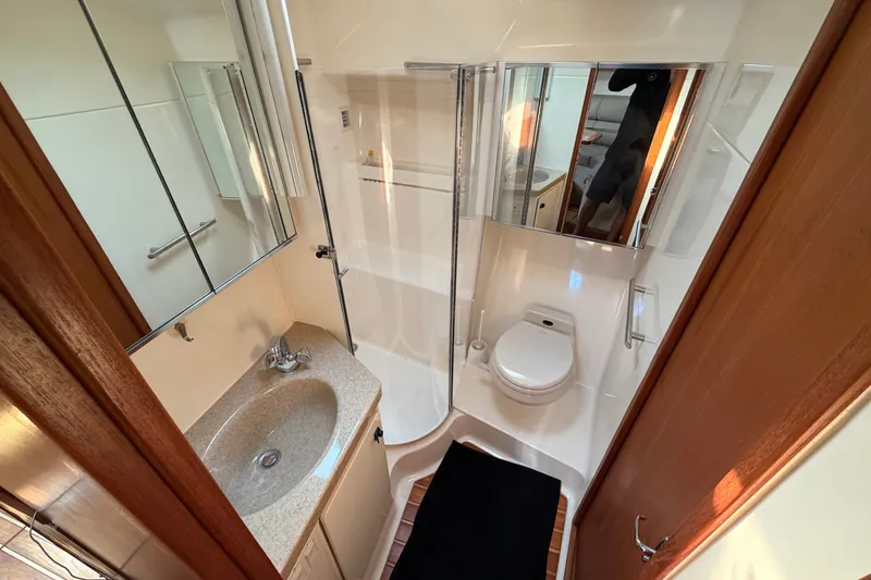 Slide: The Image of Bathroom interior of 1998 Tiara Yachts 4000 Express, featuring sink, toilet, and shower. - 21