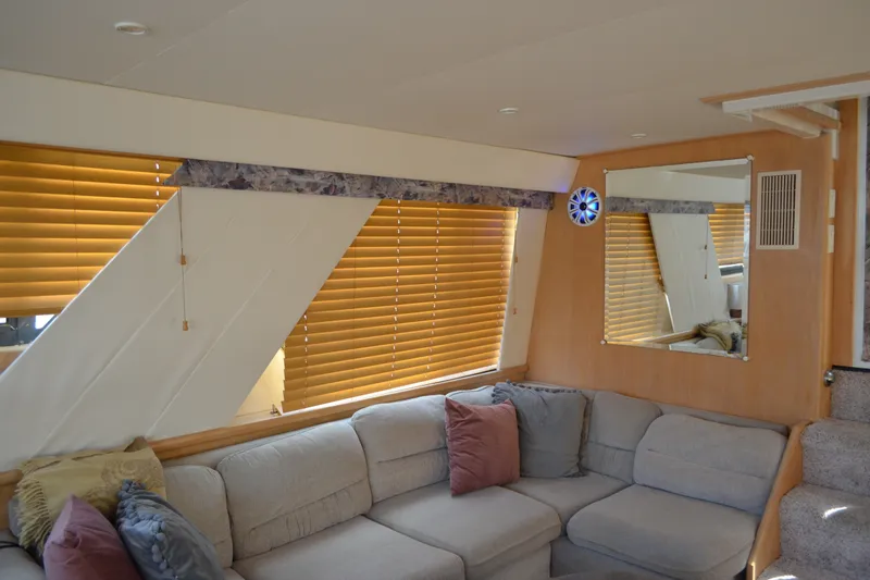 Slide: The Image of Interior of 1996 Carver 440 Aft Cabin Motor Yacht with cozy seating and wooden blinds. - 40