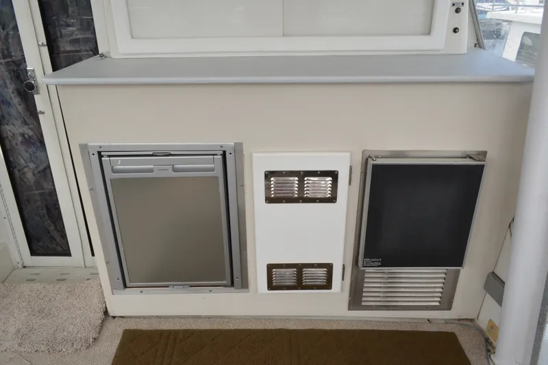 Slide: The Image of 1996 Carver 440 Aft Cabin Motor Yacht interior with built-in appliances and ventilation. - 15