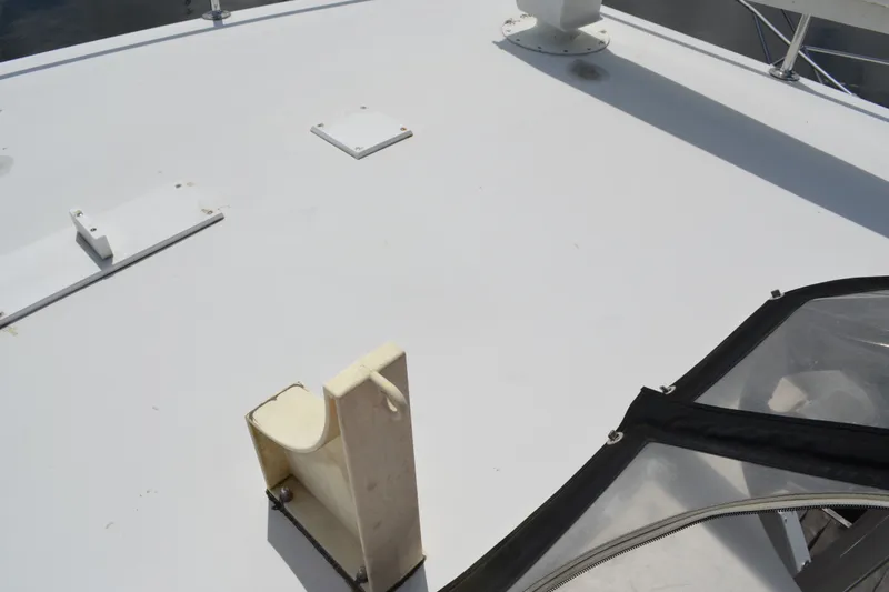 Slide: The Image of 1996 Carver 440 Aft Cabin Motor Yacht deck with hatch and railing details. - 29