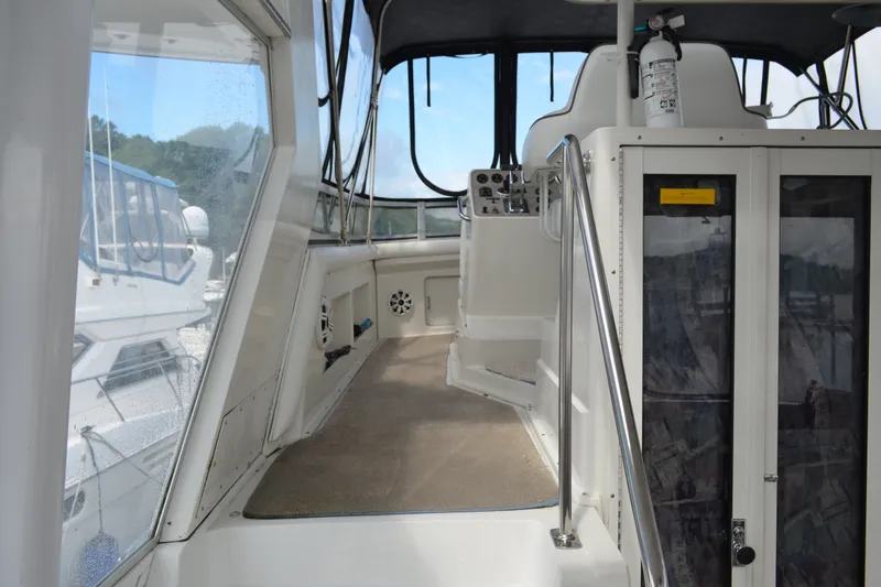 Slide: The Image of 1996 Carver 440 Aft Cabin Motor Yacht interior with helm and seating area. - 17
