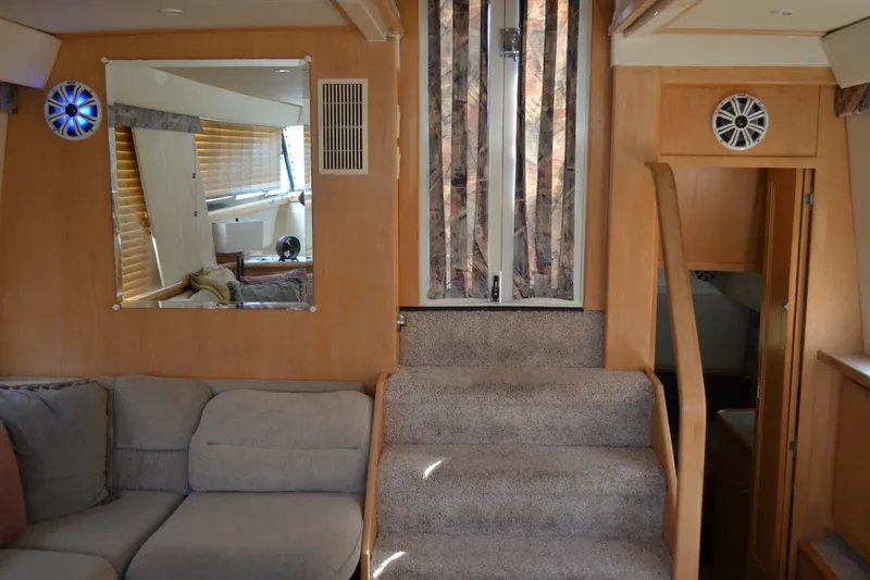 Slide: The Image of Interior of 1996 Carver 440 Aft Cabin Motor Yacht with cozy seating and carpeted stairs. - 39