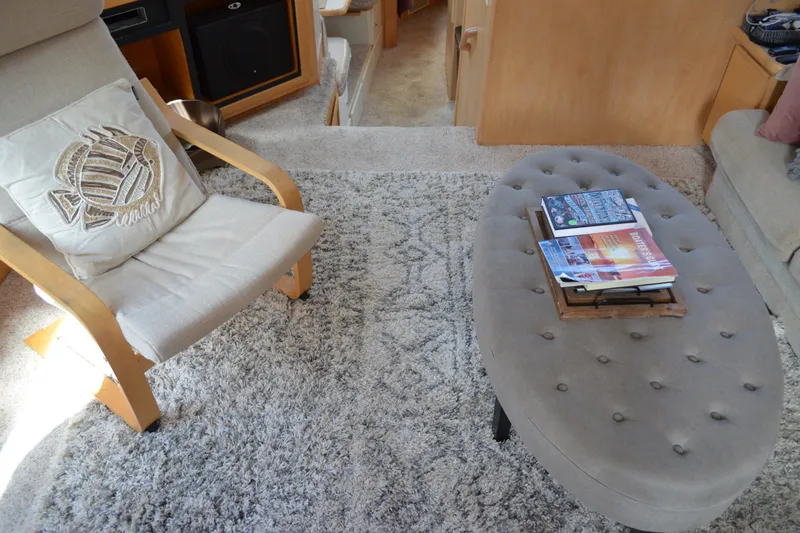 Slide: The Image of Cozy interior of 1996 Carver 440 Aft Cabin Motor Yacht with chair, cushion, and tufted ottoman. - 31