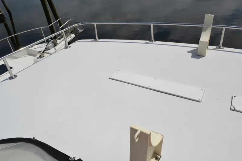 Slide: The Image of 1996 Carver 440 Aft Cabin Motor Yacht deck with railing and water view. - 28