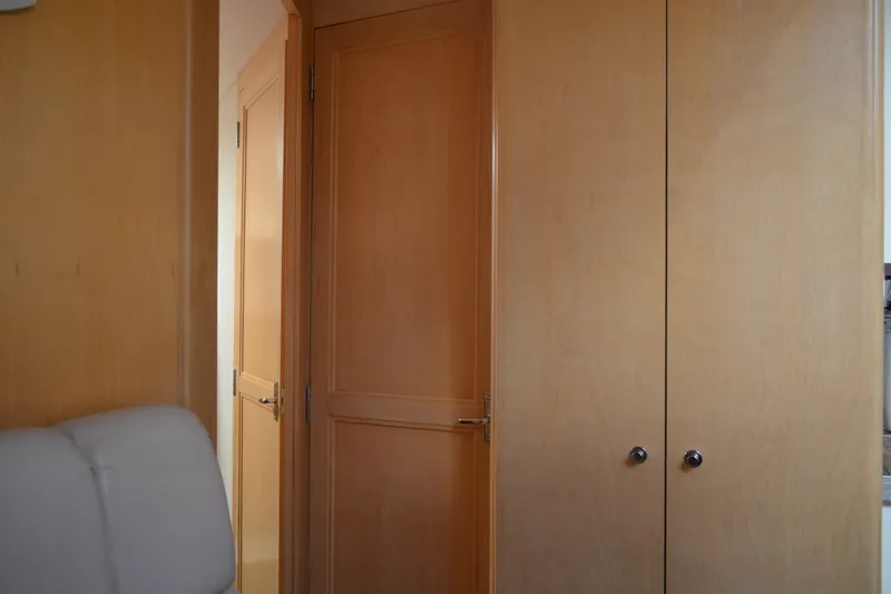 Slide: The Image of Interior of 1996 Carver 440 Aft Cabin Motor Yacht with wooden doors and cabinetry. - 48