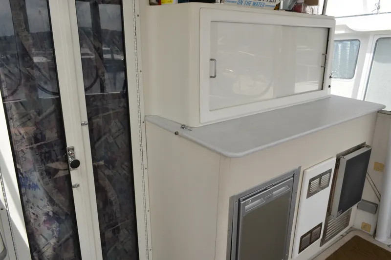 Slide: The Image of Interior view of 1996 Carver 440 Aft Cabin Motor Yacht with storage and appliances. - 16