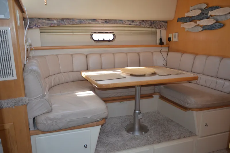 Slide: The Image of 1996 Carver 440 Aft Cabin Motor Yacht interior with cozy dining area and plush seating. - 44