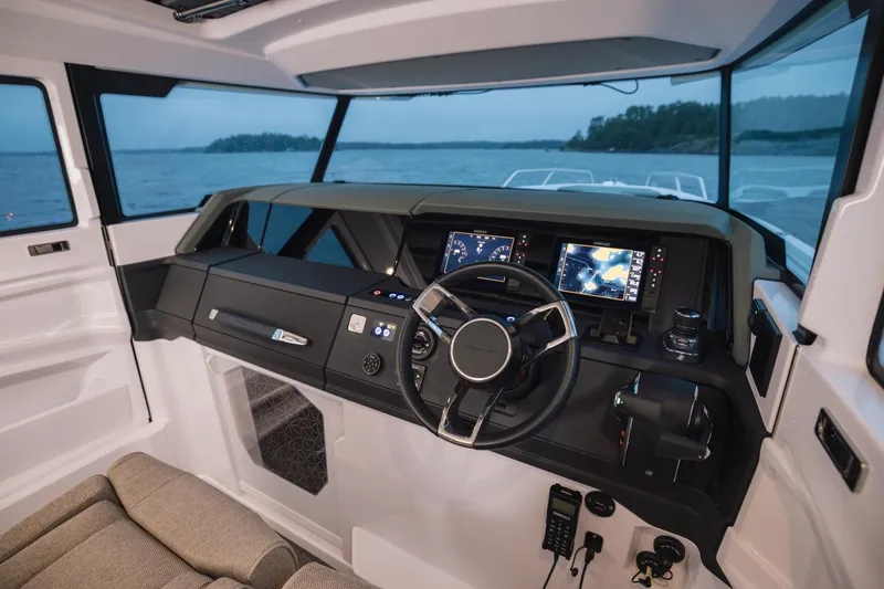 Slide: The Image of Interior view of 2027 Axopar 38 Cross Cabin boat with modern dashboard and steering. - 18