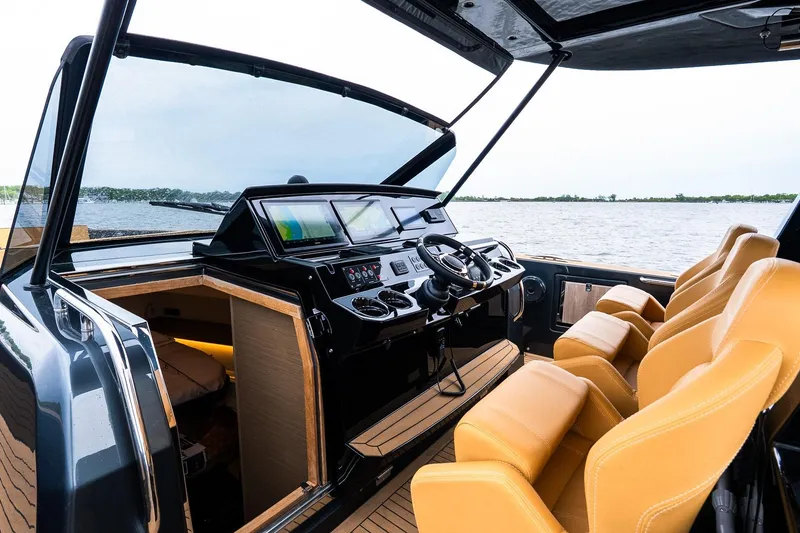 Slide: The Image of Luxurious 2025 Pardo Yachts 43 interior with modern helm and tan seating. - 25