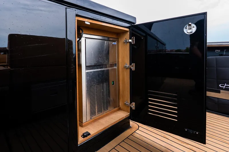 Slide: The Image of Open storage compartment on 2025 Pardo Yachts 43, featuring sleek black and wood design. - 20