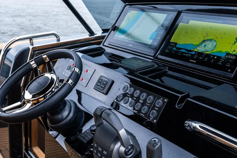 Slide: The Image of 2025 Pardo Yachts 43 helm with advanced navigation displays and sleek steering wheel. - 28