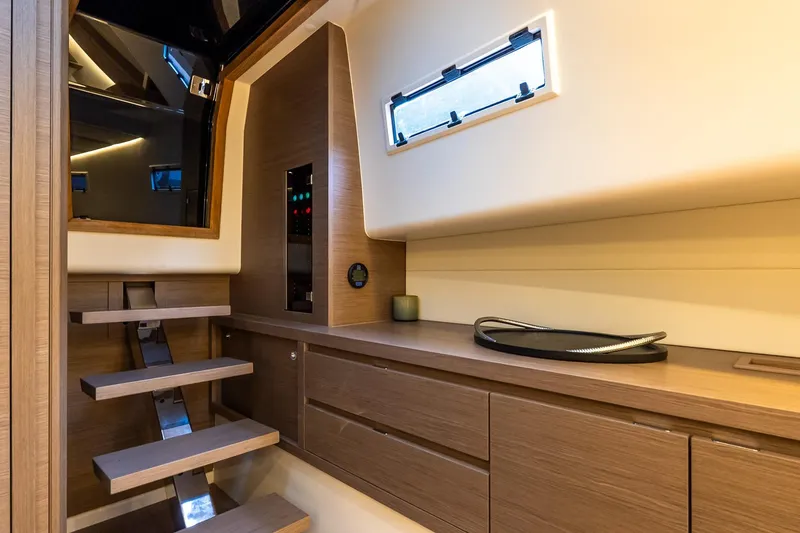 Slide: The Image of Interior of 2025 Pardo Yachts 43, featuring modern wooden cabinetry and sleek design. - 45