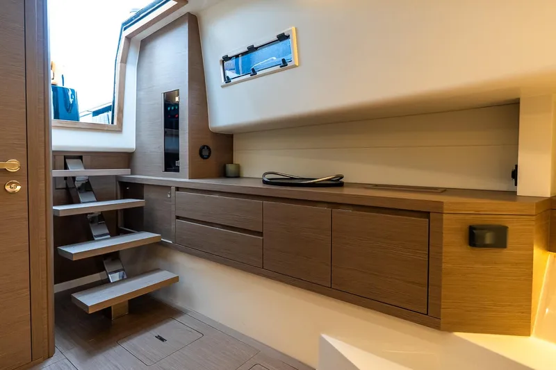 Slide: The Image of Interior of 2025 Pardo Yachts 43, featuring modern wooden cabinetry and sleek staircase design. - 42