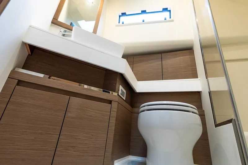 Slide: The Image of Modern bathroom interior of 2025 Pardo Yachts 43, featuring sleek wood cabinetry and compact design. - 54