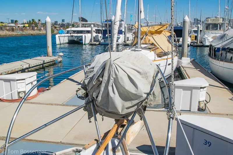 Slide: The Image of 1973 Challenger 32 sailboat docked at marina, sunny day, calm waters, covered sail. - 33
