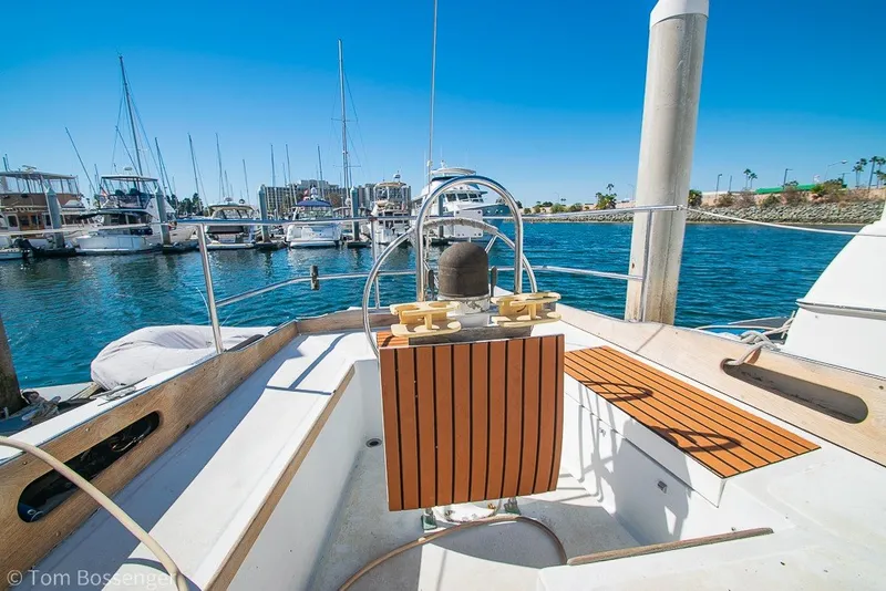 Slide: The Image of 1973 Challenger 32 sailboat docked in a marina under clear blue skies. - 25
