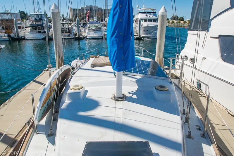 Slide: The Image of 1973 Challenger 32 sailboat docked in a marina, surrounded by other boats. - 35