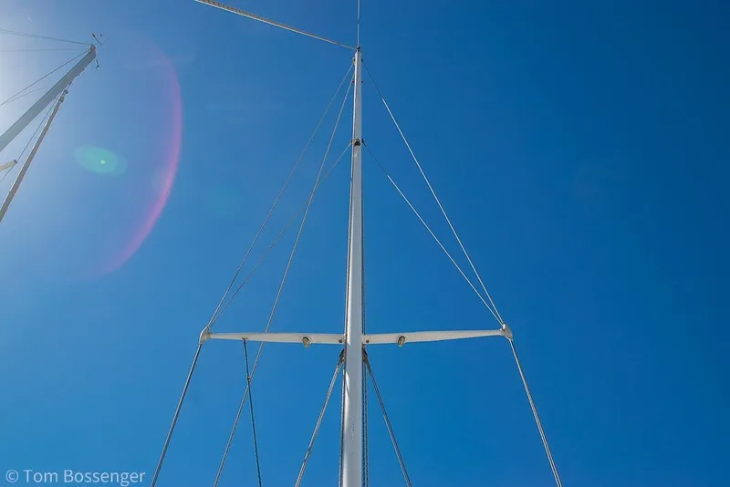 Slide: The Image of Mast of 1973 Challenger 32 sailboat against clear blue sky. - 34