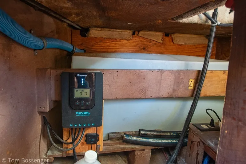 Slide: The Image of Electrical setup inside a 1973 Challenger 32 boat, featuring a Renogy Rover charge controller. - 23