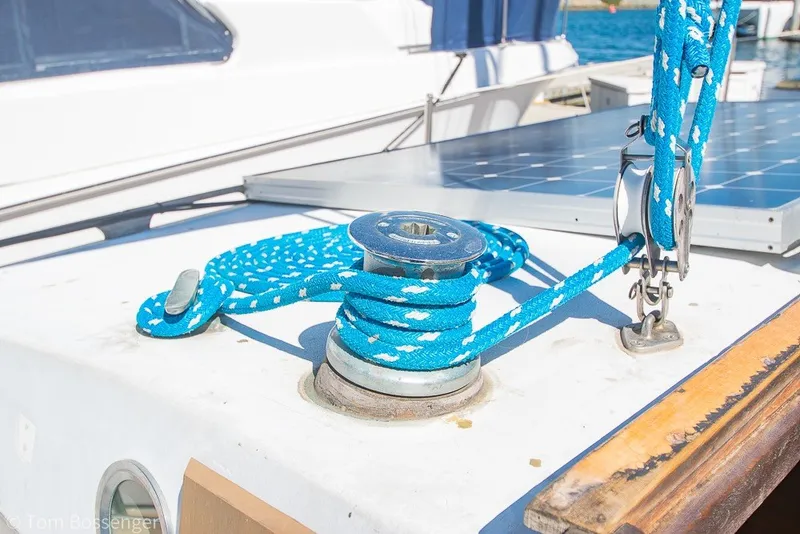 Slide: The Image of Blue rope on a 1973 Challenger 32 sailboat deck with winch and solar panel. - 30