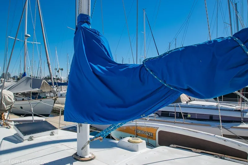 Slide: The Image of 1973 Challenger 32 sailboat with blue sail cover in a marina. - 32