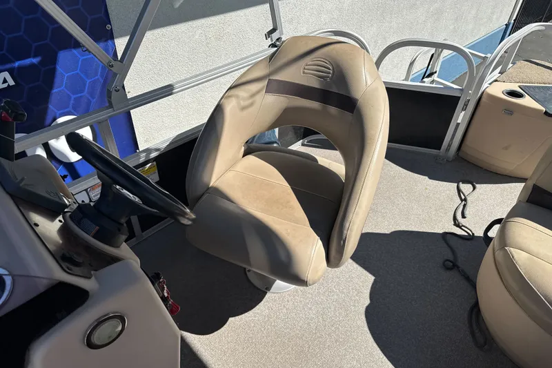 Slide: The Image of 2019 Sun Tracker Bass Buggy 18 DLX boat interior with steering wheel and seating. - 17