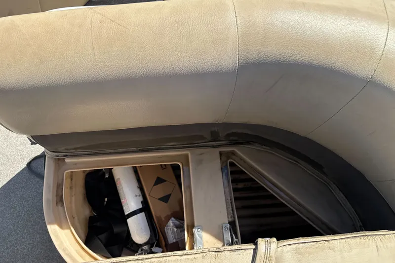Slide: The Image of 2019 Sun Tracker Bass Buggy 18 DLX storage compartment with seat cushion and equipment. - 20