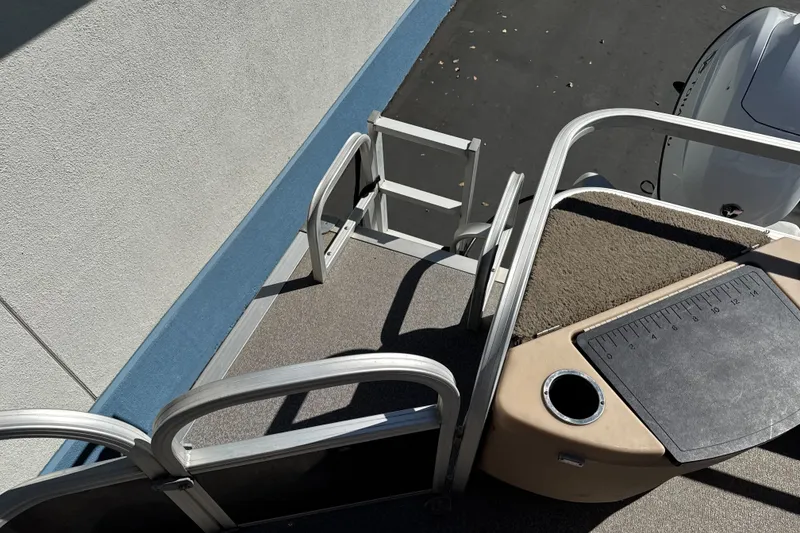 Slide: The Image of 2019 Sun Tracker Bass Buggy 18 DLX boat deck with ladder and fishing station. - 22