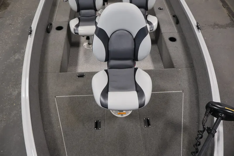 Slide: The Image of 2015 Alumacraft Classic 165 Tiller boat interior with gray seating and carpeted flooring. - 16