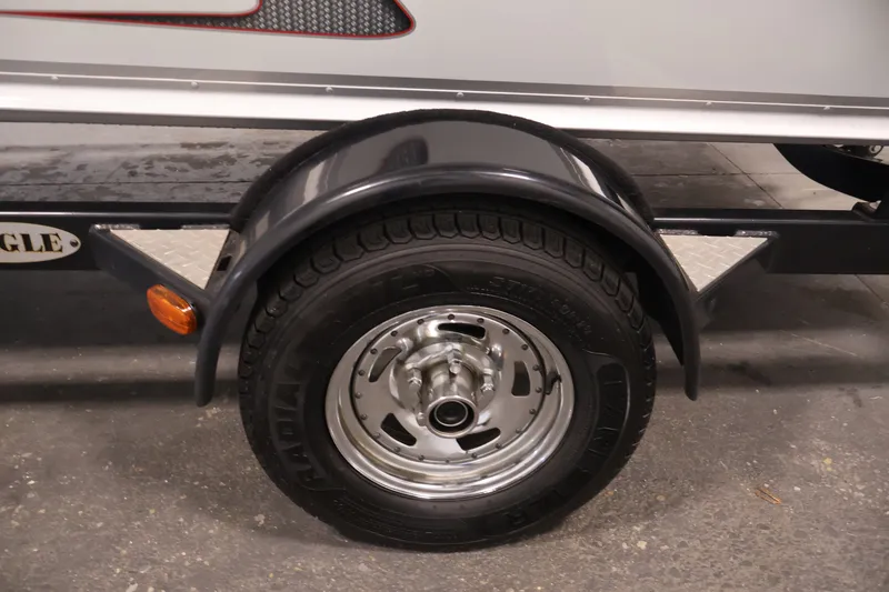 Slide: The Image of Trailer wheel of 2015 Alumacraft Classic 165 Tiller boat, featuring black fender. - 34