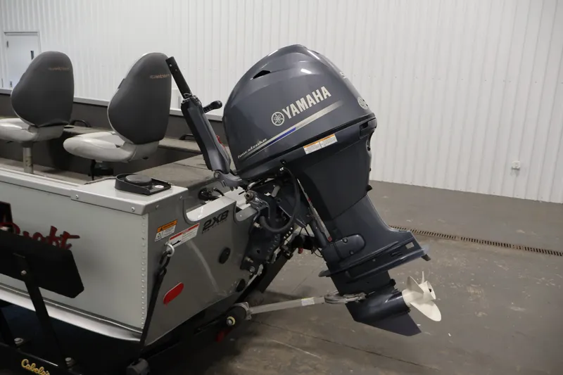 Slide: The Image of 2015 Alumacraft Classic 165 Tiller with Yamaha outboard motor in a garage setting. - 27