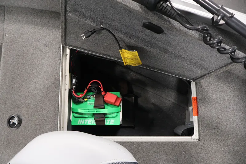Slide: The Image of 2015 Alumacraft Classic 165 Tiller boat battery compartment with green Interstate battery. - 18