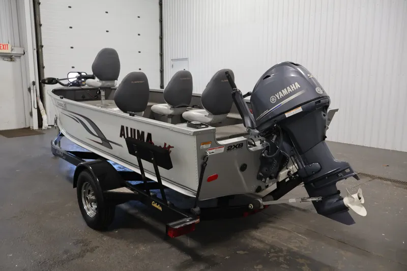 Slide: The Image of 2015 Alumacraft Classic 165 Tiller boat with Yamaha motor in indoor setting. - 7
