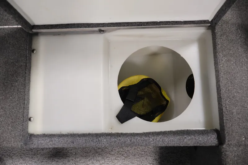 Slide: The Image of Storage compartment in 2015 Alumacraft Classic 165 Tiller boat with yellow mesh bag. - 21