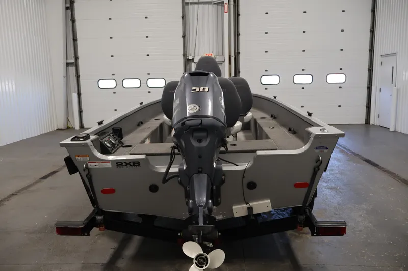 Slide: The Image of 2015 Alumacraft Classic 165 Tiller boat with Yamaha outboard motor in a garage setting. - 6