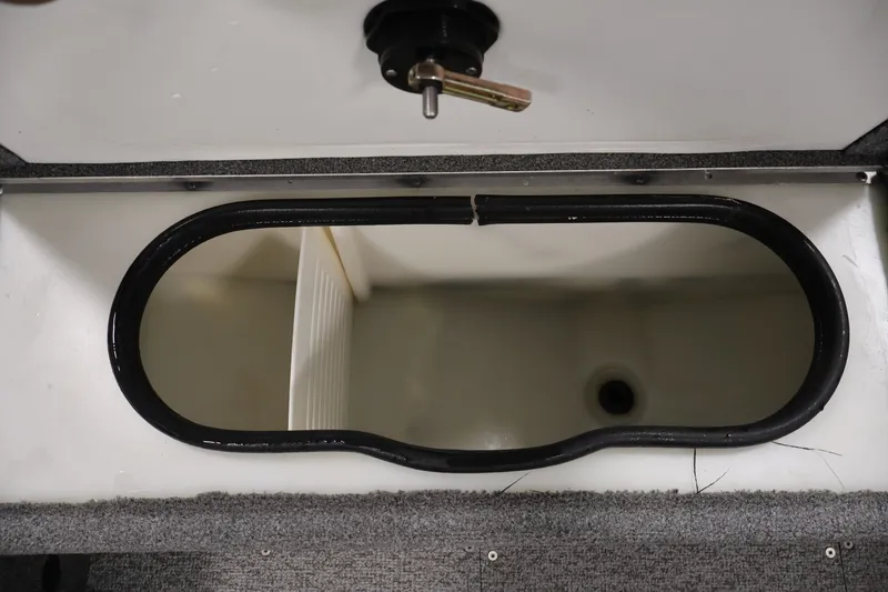 Slide: The Image of 2015 Alumacraft Classic 165 Tiller livewell compartment with open lid and drain plug. - 20