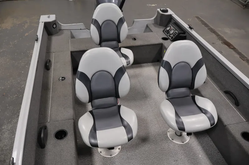Slide: The Image of 2015 Alumacraft Classic 165 Tiller boat interior with three gray seats. - 22