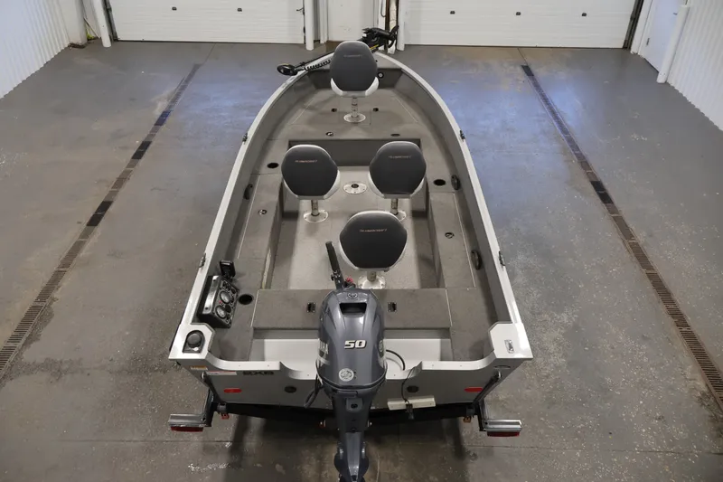 Slide: The Image of 2015 Alumacraft Classic 165 Tiller boat with Yamaha 50 engine in a garage setting. - 10