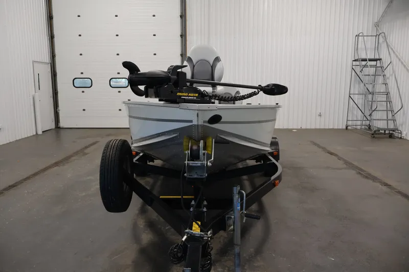Slide: The Image of 2015 Alumacraft Classic 165 Tiller boat on trailer in indoor storage facility. - 3
