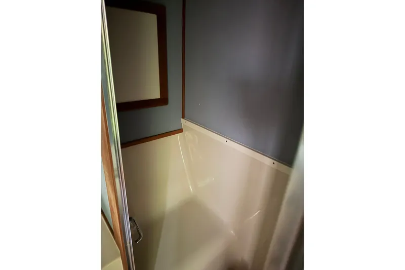 Slide: The Image of Interior of 1988 Silverton 37 Convertible boat bathroom with shower and mirror. - 15