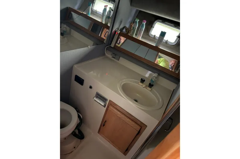 Slide: The Image of Bathroom interior of 1988 Silverton 37 Convertible yacht, featuring sink and mirror. - 14