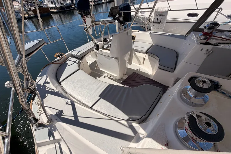 Slide: The Image of Spacious cockpit of a 2002 Hunter 460 sailboat with cushioned seating and steering wheel. - 21
