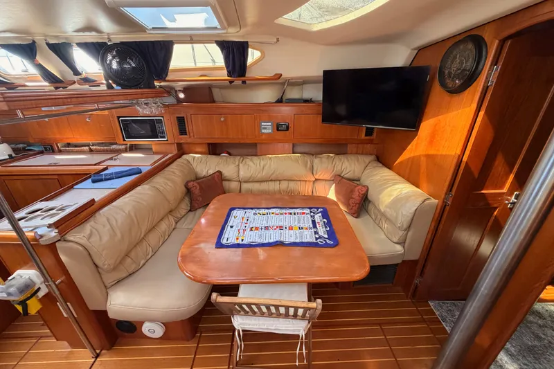 Slide: The Image of Luxurious interior of a 2002 Hunter 460 yacht with cozy seating and modern amenities. - 62