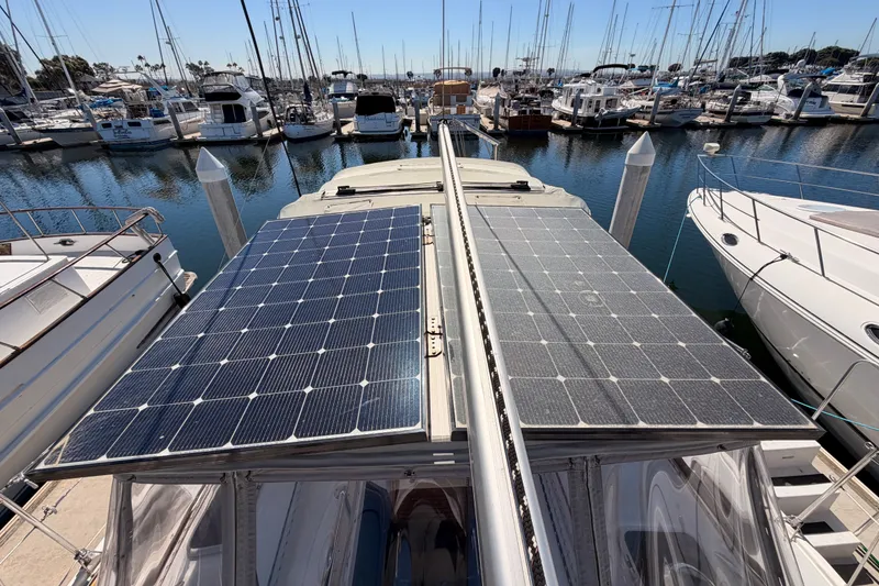 Slide: The Image of Hunter 460 yacht with solar panels docked at a marina, 2002 model. - 20