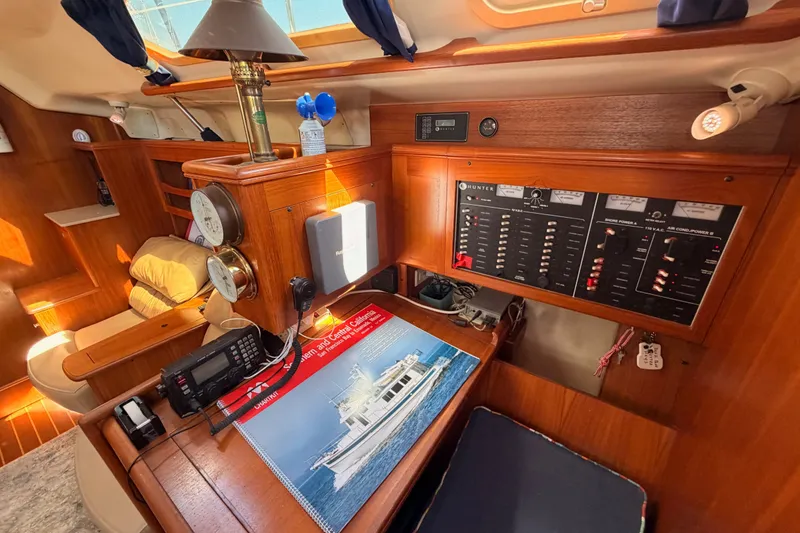 Slide: The Image of Interior of 2002 Hunter 460 sailboat with navigation equipment and control panels. - 60