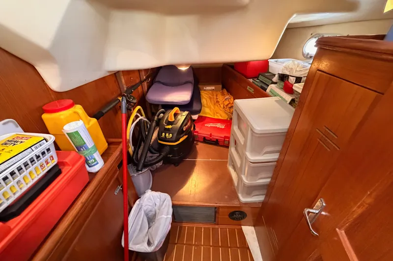 Slide: The Image of Interior of a 2002 Hunter 460 sailboat storage area with organized supplies and equipment. - 45