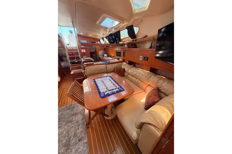 Slide: The Image of Luxurious interior of 2002 Hunter 460 yacht with plush seating and elegant wood finishes. - 74