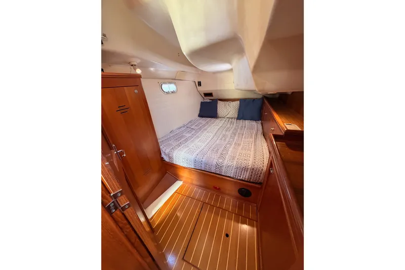 Slide: The Image of Cozy cabin interior of 2002 Hunter 460 yacht with wooden finishes and bed. - 55