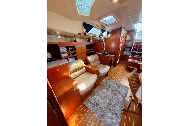 Slide: The Image of Interior of 2002 Hunter 460 yacht with wooden furnishings and cozy seating area. - 73